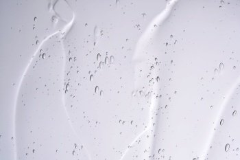 The texture of a cosmetic gel with bubbles on a white background.
