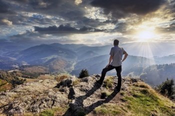 a hiker enjoys the view from Belchen mountain