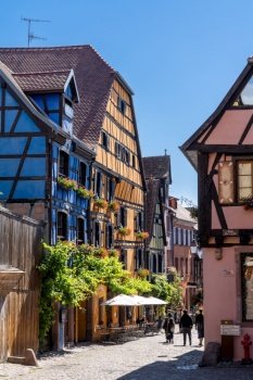 Riquewihr, France - 30 May, 2022: historic colorful half-timbered houses in the Alsatian town of Riquewihr