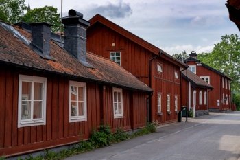 Trosa, Sweden - 22 June, 2021: typical red Swedish wooden houses line the streets of the historic city center of downtown Trosa