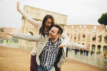 Loving couple having fun in front of  Colosseum in Rome