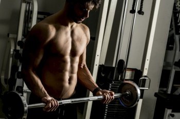 Handsome young man training in the gym