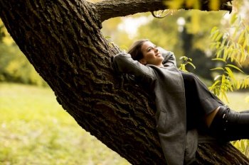 oung woman resting on the tree