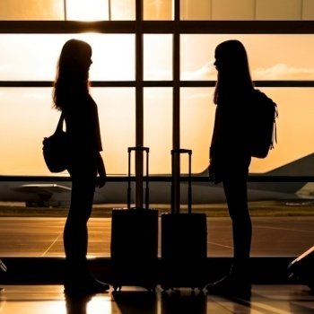 silhouettes of girls with luggage at the airport  travel flight generative ai.