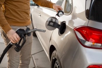 Car refueling on the petrol station. Hand refilling the car with fuel. Close up view. Gasoline, diesel is getting more expensive. Car refueling on the petrol station. Hand refilling the car with fuel. Close up view. Gasoline, diesel is getting more expensive.