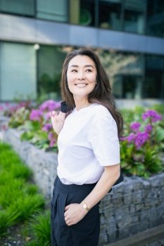 Asian confident business woman in suit. Bright future of career opportunities concept. Spring background of office center. Business people lifestyle. Asian confident business woman in suit smiling, looking up. Spring season