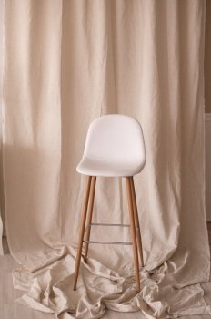 White chair with long wooden legs in the interior