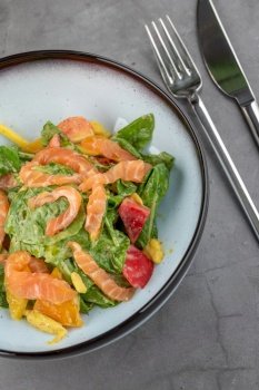 Salmon salad on stone table in fine dining restaurant