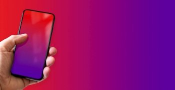 Hand holding a smartphone with blank red and purple screen. Colorful background. Horizontal banner.. Hand holding a smartphone with blank red and purple screen. Colorful horizontal banner.