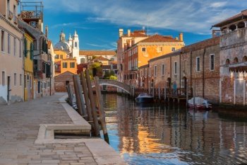 Typical Venetian canal with bridge and church in the early morning, Dorsoduro, Venice, Italy. Typical Venetian canal in Venice, Italy