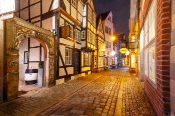 Medieval Bremen street Schnoor with half-timbered houses in the centre of the Hanseatic City of Bremen at night, Germany. Medieval street Schnoor in Bremen, Germany