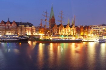 Night view of the Weser River and Protestant Lutheran Saint Martin Church in the old town of Bremen, Germany.. Weser River and St Martin Church, Bremen, Germany