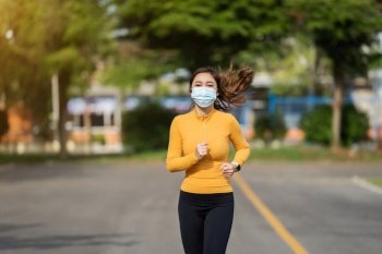 young woman running with medical mask to protect Coronavirus(Covid-19) pandemic