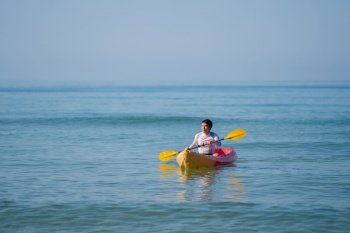 man paddling a kayak boat in the sea