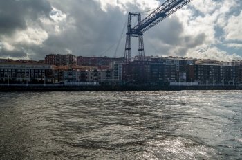View from Getxo, Spain: the famous Vizcaya Bridge built in 1893, declared a World Heritage Site by UNESCO and the town of Portugalete in the background