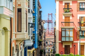 Colorful facades in the old town of  Portugalete, Spain, with the famous Vizcaya Bridge in the background