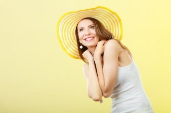 Holidays and summer fashion. Woman in big yellow hat. Portrait of charming female on bright background.