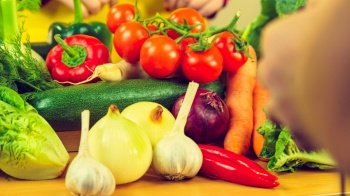 Many healthy colorful vegetables on kitchen table. Dieting, vegetarian local fresh food, natural source of vitamins.. Many healthy colorful vegetables