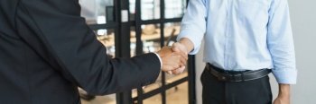 Lawyer and legal concept, Businessman and senior lawyer shake hands after successful deal contract.