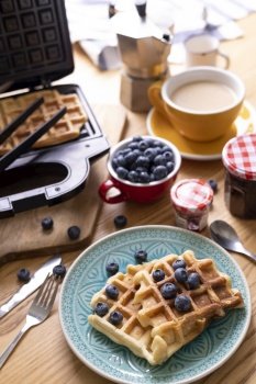 morning and bright breakfast. belgian waffles with blueberries and coffee
