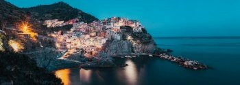 panorama view of Manarola village one of Cinque Terre at night in La Spezia, Italy