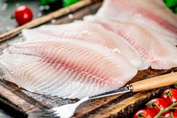 Fresh fish fillet on a cutting board. Macro background. High quality photo. Fresh fish fillet on a cutting board. 