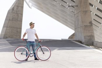 Young male Biking in a Summer Day on the city