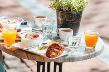 Fresh and delisious breakfast in outdoor cafe at european city. Coffee with food on table for breakfast. Fresh and delisious breakfast in outdoor cafe at european city