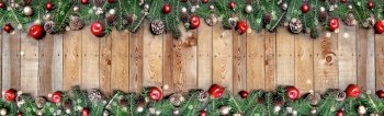 panoramic frame of christmas decoration with copy space in the middle on a plank. panoramic frame of christmas decoration with copy sapce in the middle on a plank