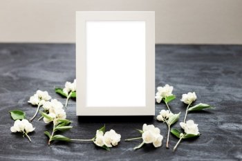 Flat lay top view mockup of a frame on a black background with wild flowers. Beautiful trendy layout photo.. Flat lay top view mockup photo of a frame on a black background with wild flowers.