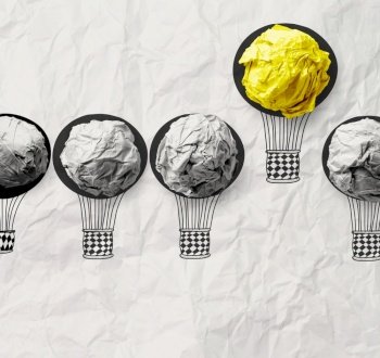 hand drawn air balloons with crumpled paper ball as leadership concept