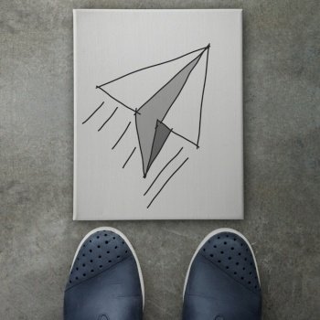 Hand drawn paper plane  icon on canvas board on front of business man feet as concept 
