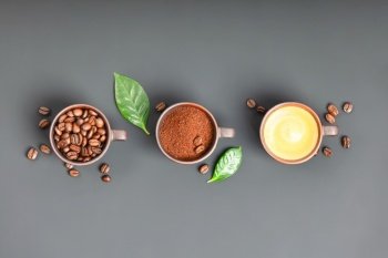 Coffee composition with three cups of coffee on dark background, banner, flat lay