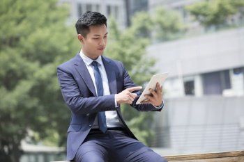 Confident businessman using a tablet computer