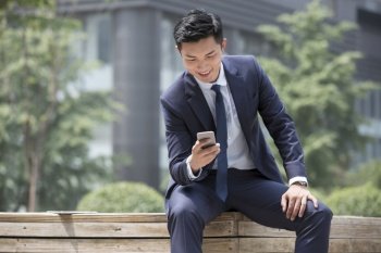 Confident businessman staring at his phone