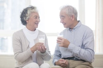 Happy old couple drinking milk