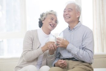 Happy old couple drinking milk