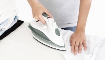 unrecognisable lady ironing clothes. Resolution and high quality beautiful photo. unrecognisable lady ironing clothes. High quality beautiful photo concept
