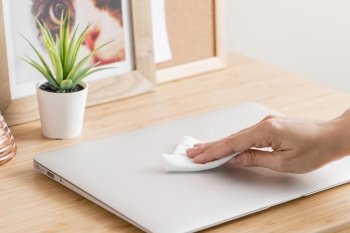 high angle hand disinfecting laptop desk. Beautiful photo. high angle hand disinfecting laptop desk