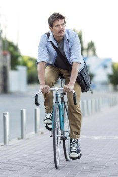 portrait man riding bicycle city