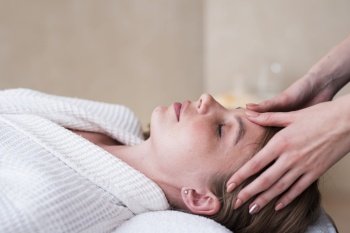 woman getting head massage spa