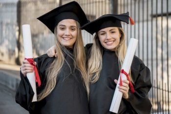 college graduates smiling camera