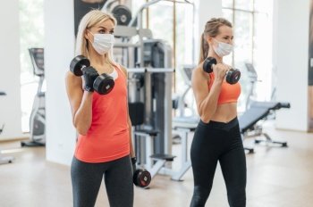 women gym doing training with medical mask