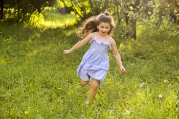 cute little girl running garden