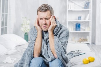 young man suffering from cold having headache