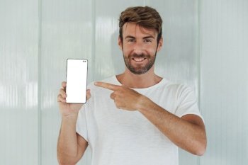 smiley bearded man showing cellphone