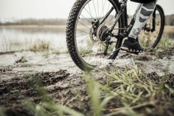 low section male cyclist riding bicycle mud