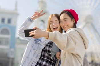 girlfriends taking selfie with london eye