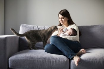 woman feeding child couch