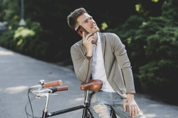 man sitting bicycle talking mobile phone
